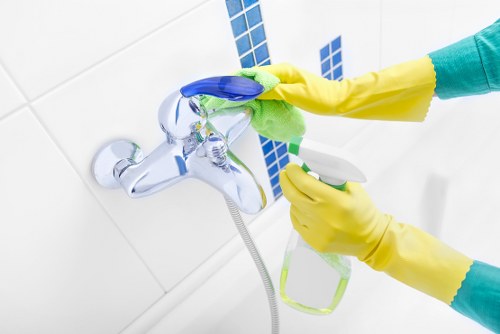 Office cleaning supplies and sanitized workspace surfaces